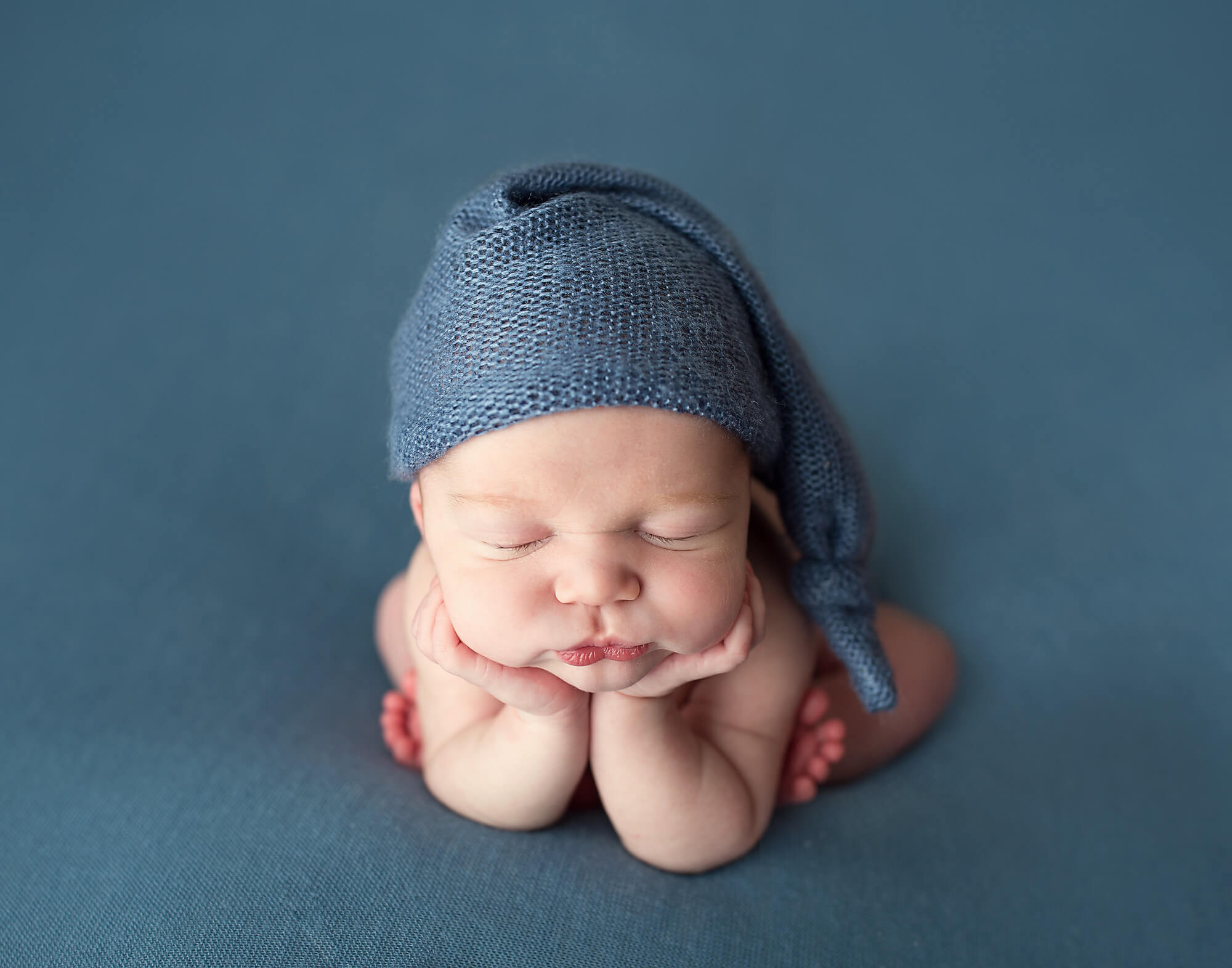 Baby boy in blue in froggy pose newborn photographer australia